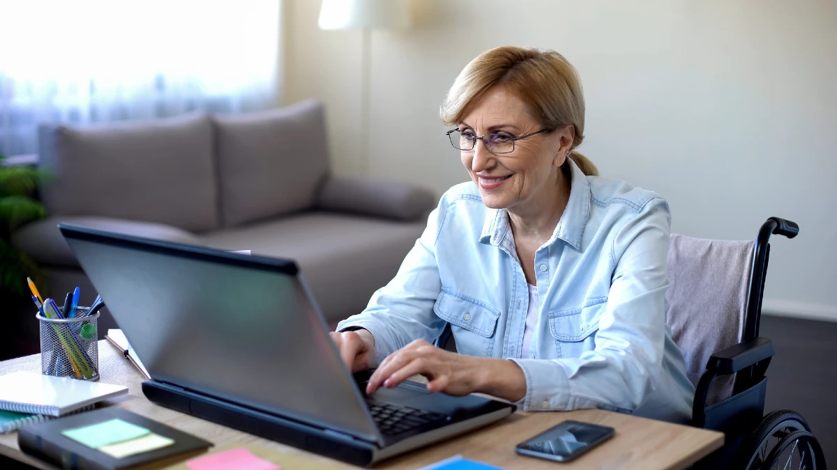 Image of woman in wheelchair using a laptop